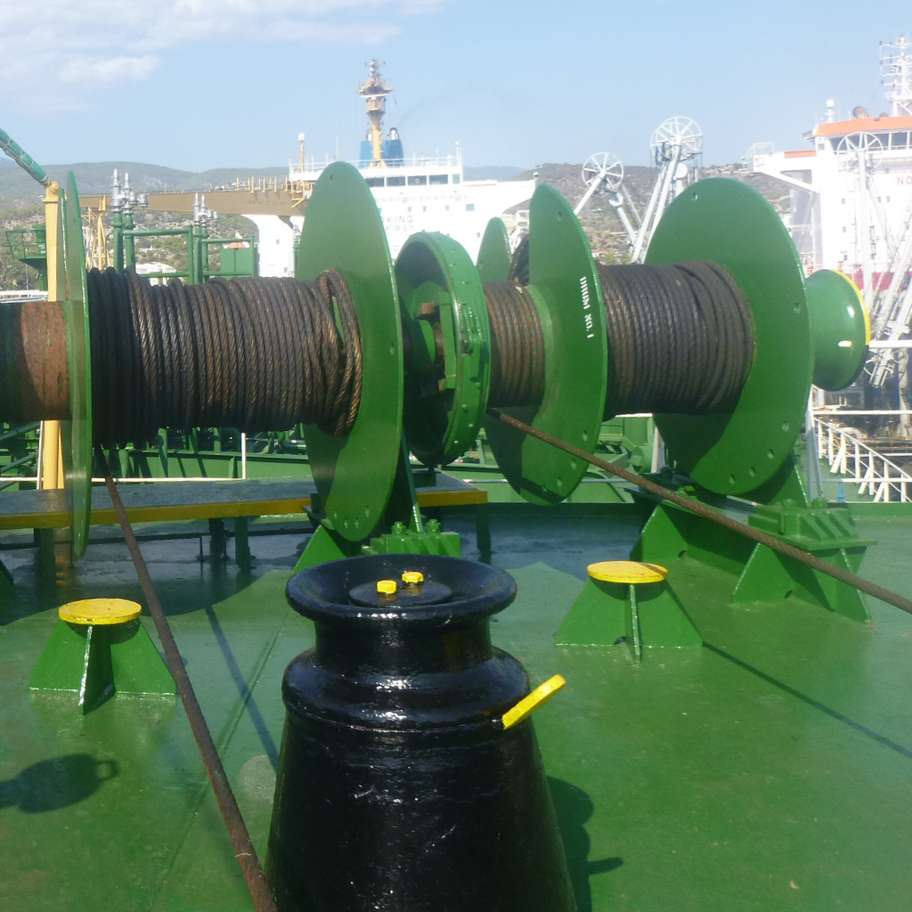 Steel wire ropes coiled on a marine winch system aboard a vessel, demonstrating proper installation techniques and adherence to MEG4 maritime safety guidelines.