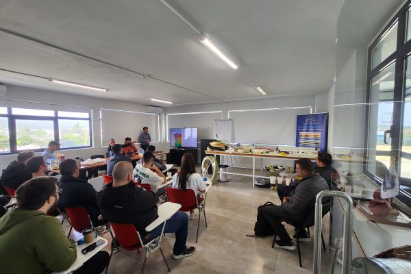 aritime training session in progress at Katradis Marine Ropes Industry S.A., featuring industry professionals learning about safe mooring operations and international maritime standards in a classroom setting.